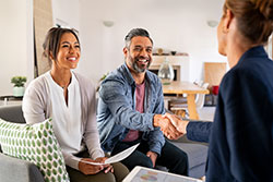 couple shaking hands with realtor