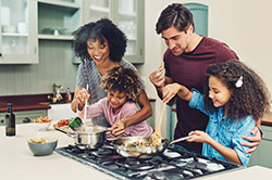 family cooking in kitchen