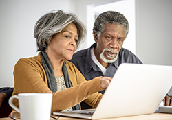 Mature couple looking at laptop