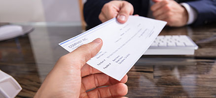 Two people handling a check