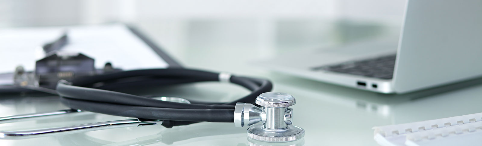 Closeup of stethoscope and laptop