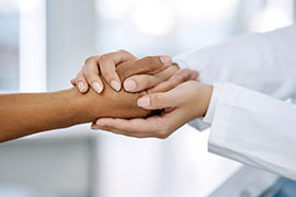 doctor holding patient's hand