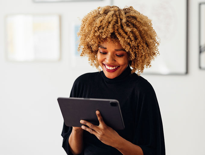 woman smiling with a tablet