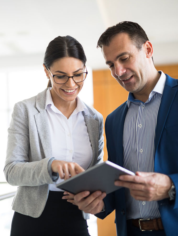 coworkers looking at a tablet in office