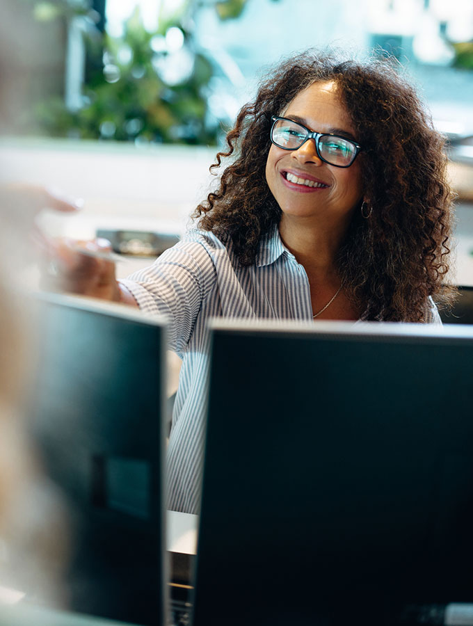 woman smiling at desktop computer