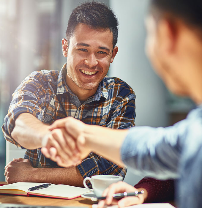 man shaking hands with another man