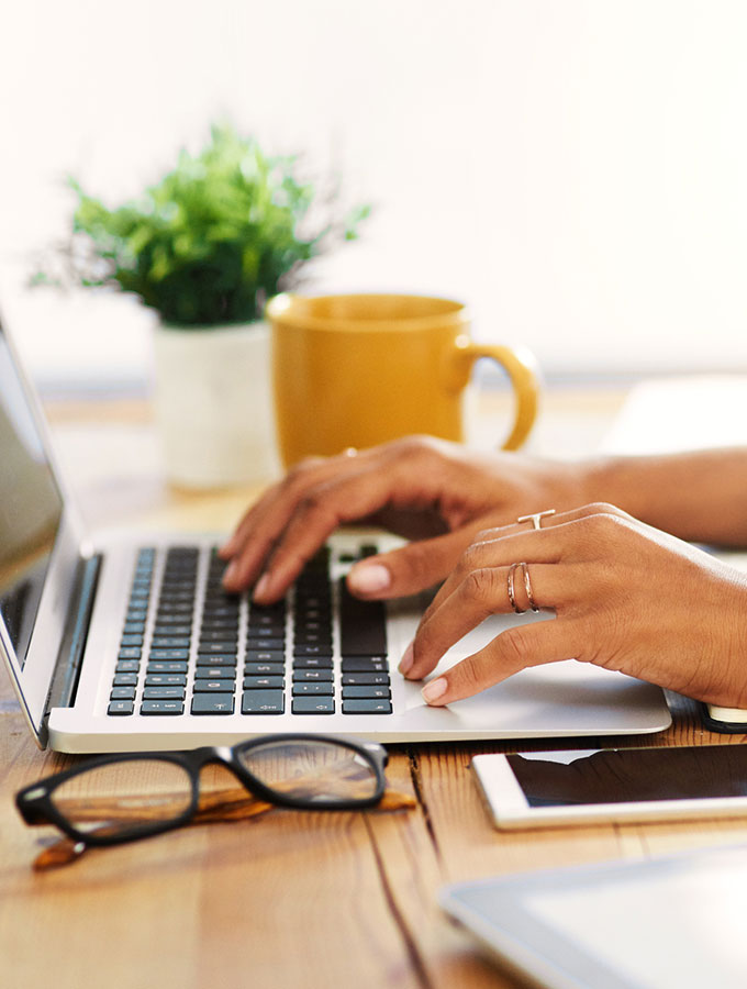 hands on a laptop