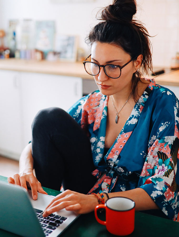 woman at home with a laptop and coffee